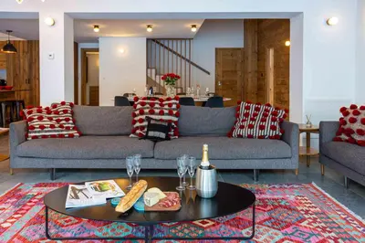 a living room with a couch and a table at Chalet Gloribel in Chamonix-Mont-Blanc