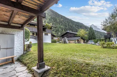 a view from the porch of a house with a grass yard at Appartement Sous-Bois - Welkeys in Chamonix-Mont-Blanc