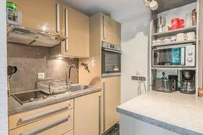 a kitchen with a sink and a counter top at Appartement Sous-Bois - Welkeys in Chamonix-Mont-Blanc