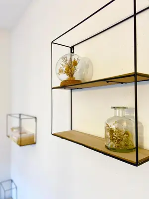 a glass shelf with a glass jar on a wall at Le refuge 'Les 4 têtes' - balcon - vue montagne - proche centre & gare in Sallanches