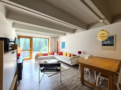 a living room with a table and a couch at Appartement confortable · Proche pistes · WIFI gratuit - FR-1-425-211 in Arâches-la-Frasse