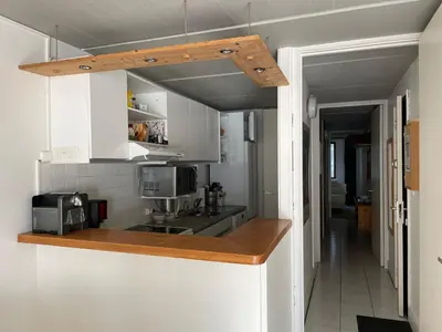 a kitchen with white cabinets and a counter top at Appartement confortable · Proche pistes · WIFI gratuit - FR-1-425-211 in Arâches-la-Frasse