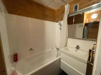 a bathroom with a white tub and a sink at Appartement confortable · Proche pistes · WIFI gratuit - FR-1-425-211 in Arâches-la-Frasse