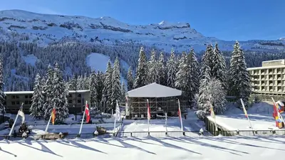 a building with a gazebo in the snow with trees at Résidence Cassiopee - Appartement tout confort · proche des pistes · WIFI gratuit · vue pistes MAE-4984 in Magland
