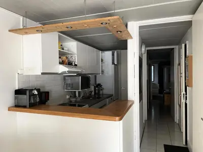 a kitchen with white cabinets and a counter top at Résidence Cassiopee - Appartement tout confort · proche des pistes · WIFI gratuit · vue pistes MAE-4984 in Magland