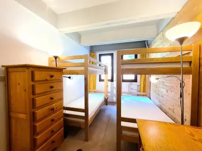 a bunk bed room with two bunk beds and a desk at Résidence Cassiopee - Appartement tout confort · proche des pistes · WIFI gratuit · vue pistes MAE-4984 in Magland