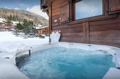 a jacuzzi tub in the snow in a cabin at Chalet Timothy - OVO Network in Samoëns