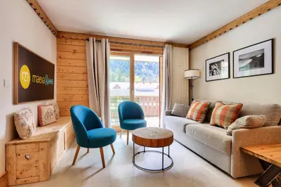 a living room with a couch and chairs and a table at Résidence La Ginabelle - maeva Home - Appartement 3 pièces 6 personnes - Prestige MAE-7151 in Chamonix-Mont-Blanc