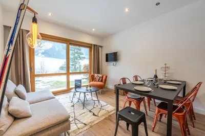 a living room with a table and a couch at Sweet Home Brevent - Happy Rentals in Chamonix-Mont-Blanc