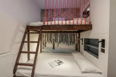 a bunk bed in a small room with a ladder at Sweet Home Brevent - Happy Rentals in Chamonix-Mont-Blanc