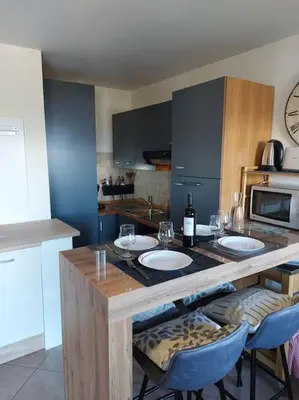 a kitchen with a counter with two white plates on it at Appartement Saint Gervais proche centre in Saint-Gervais-les-Bains