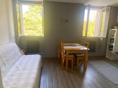 a room with a table and chairs and a bed at Appartement, au cœur de Sallanches in Sallanches