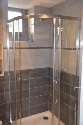 a shower with a glass door in a bathroom at Appartement, au cœur de Sallanches in Sallanches