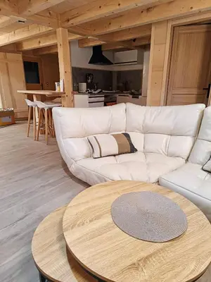 a living room with a white couch and a table at Chalet du Bonheur in Saint-Gervais-les-Bains