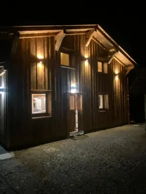 a wooden building with lights on it at night at Chalet du Bonheur in Saint-Gervais-les-Bains