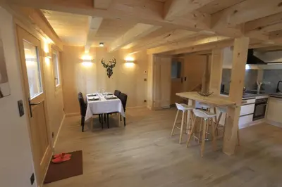 a kitchen and dining room with a table and chairs at Chalet du Bonheur in Saint-Gervais-les-Bains