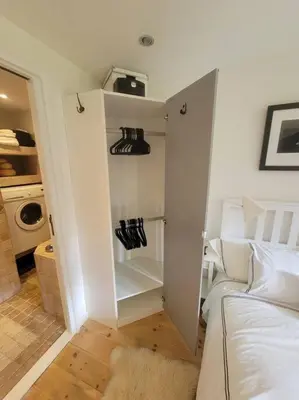 a white room with a bed and a closet at Chamonix Garden Flat with a View of Mont-Blanc - Référence XEPKMM in Chamonix-Mont-Blanc