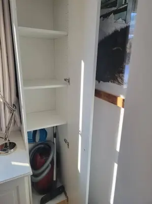 a closet with white shelves and a door in a room at Chamonix Garden Flat with a View of Mont-Blanc - Référence XEPKMM in Chamonix-Mont-Blanc
