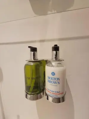 two bottles of soap sitting on a shelf at Chamonix Garden Flat with a View of Mont-Blanc - Référence XEPKMM in Chamonix-Mont-Blanc