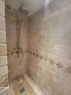 a shower stall in a bathroom with a tiled shower at Chamonix Garden Flat with a View of Mont-Blanc - Référence XEPKMM in Chamonix-Mont-Blanc