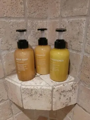 three bottles of soap on a brick wall at Chamonix Garden Flat with a View of Mont-Blanc - Référence XEPKMM in Chamonix-Mont-Blanc