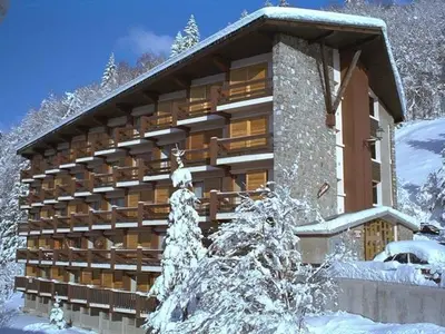 a building in the snow with snow covered trees at Duplex de 100m² pour 9 personnes au centre proche remontées mécaniques - FR-1-572-290 in Arâches-la-Frasse