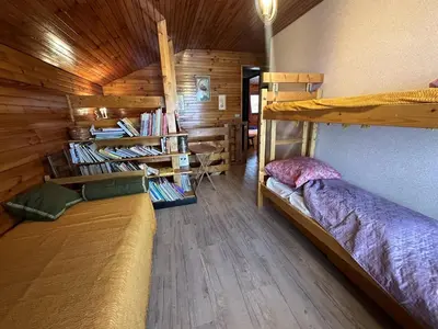 a room with two bunk beds in a cabin at Duplex de 100m² pour 9 personnes au centre proche remontées mécaniques - FR-1-572-290 in Arâches-la-Frasse