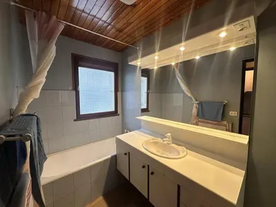 a bathroom with a sink and a tub and a mirror at Duplex de 100m² pour 9 personnes au centre proche remontées mécaniques - FR-1-572-290 in Arâches-la-Frasse