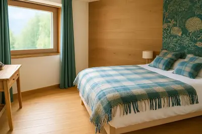 a bedroom with a bed and a window at Chalet Anatole - Vue Mont Blanc Exceptionnelle in Saint-Gervais-les-Bains