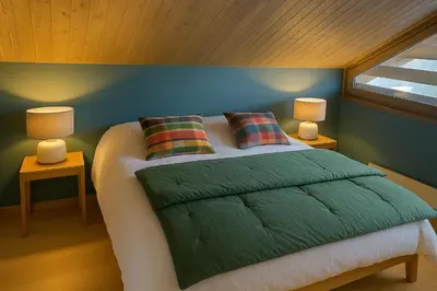 a bedroom with a bed with two lamps on it at Chalet Anatole - Vue Mont Blanc Exceptionnelle in Saint-Gervais-les-Bains