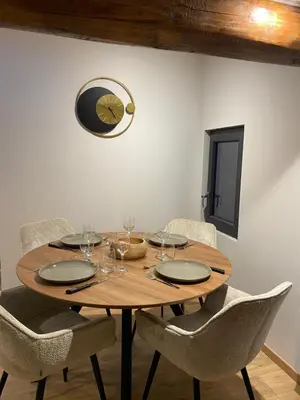a wooden table with chairs and wine glasses on it at CHALET CAREVA in Les Houches