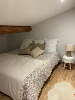 a bedroom with a large bed with a wooden headboard at CHALET CAREVA in Les Houches
