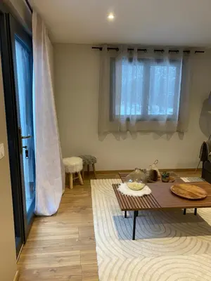 a living room with a table and a window at CHALET CAREVA in Les Houches