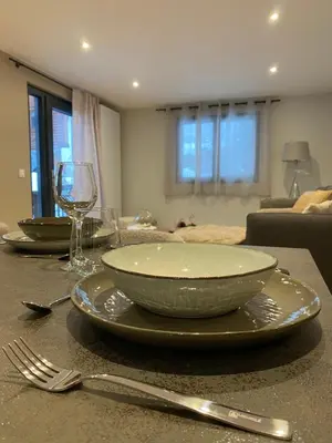 a table with two plates and a glass of wine at CHALET CAREVA in Les Houches