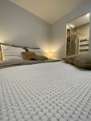 a bedroom with a large bed with white sheets at CHALET CAREVA in Les Houches