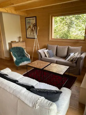 a living room with a couch and a table at Chalet Charline in Combloux