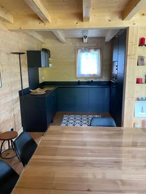 a dining room with a large wooden table and chairs at Chalet Charline in Combloux
