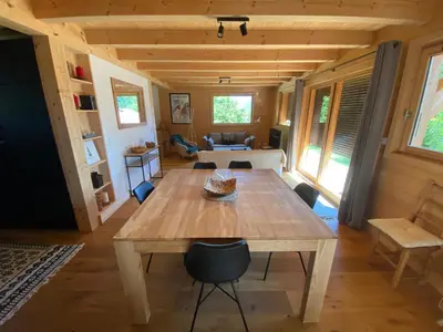 a dining room with a wooden table and chairs at Chalet Charline in Combloux