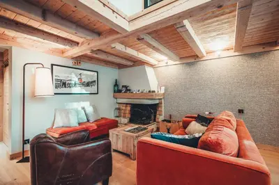 a living room with two couches and a fireplace at Appartement Keraos - Perfect for a family holiday in Megeve in Megève