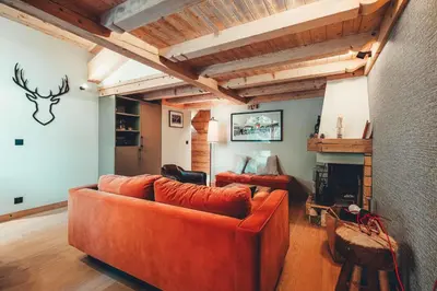 a living room with a couch and a fireplace at Appartement Keraos - Perfect for a family holiday in Megeve in Megève
