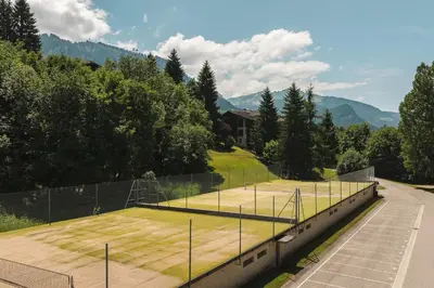 an empty tennis court with a tennis court at Appartement Keraos - Perfect for a family holiday in Megeve in Megève
