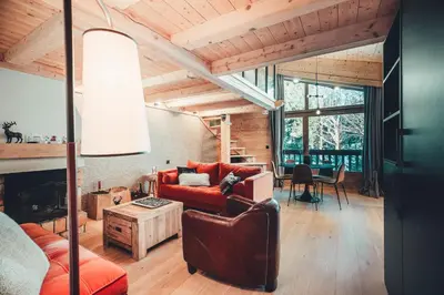 a living room with a couch and a table at Appartement Keraos - Perfect for a family holiday in Megeve in Megève