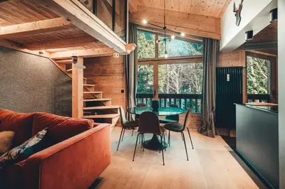 a living room with a couch and a table at Appartement Keraos - Perfect for a family holiday in Megeve in Megève