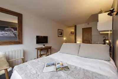 a bedroom with a bed with two books on it at Le Cham' 106 - Happy Rentals in Chamonix-Mont-Blanc
