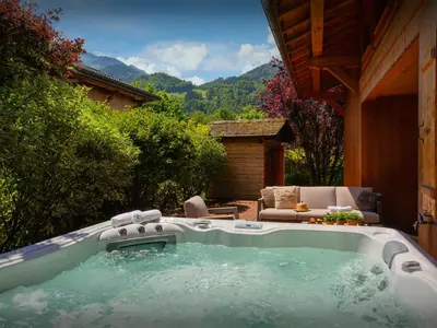 a hot tub in the backyard of a house at Chalet Evonyx - OVO Network in Samoëns