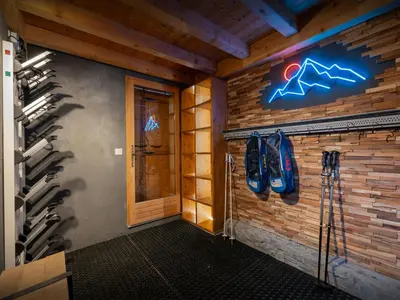 a room with a wall full of ski equipment at Chalet Evonyx - OVO Network in Samoëns