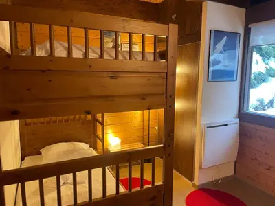 a wooden bunk bed in a room with a window at Apartment Clos du Chantey Moury by Interhome in Chamonix-Mont-Blanc