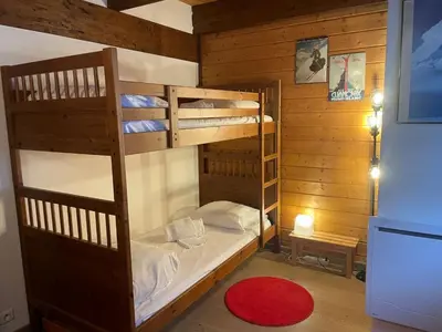 a bedroom with two bunk beds and a red rug at Apartment Clos du Chantey Moury by Interhome in Chamonix-Mont-Blanc