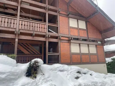 a building with a pile of snow in front of it at Apartment Clos du Chantey Moury by Interhome in Chamonix-Mont-Blanc
