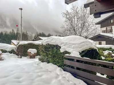 a pile of snow on a fence in a yard at Apartment Clos du Chantey Moury by Interhome in Chamonix-Mont-Blanc